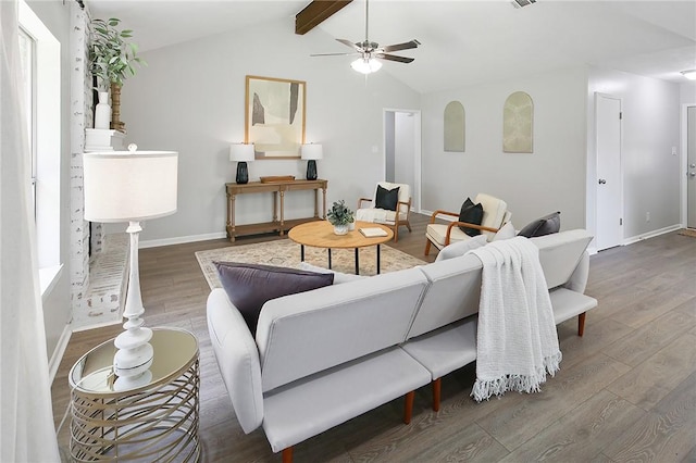 living area featuring baseboards, a ceiling fan, visible vents, vaulted ceiling with beams, and wood finished floors