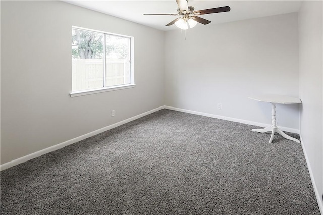 carpeted empty room featuring ceiling fan and baseboards