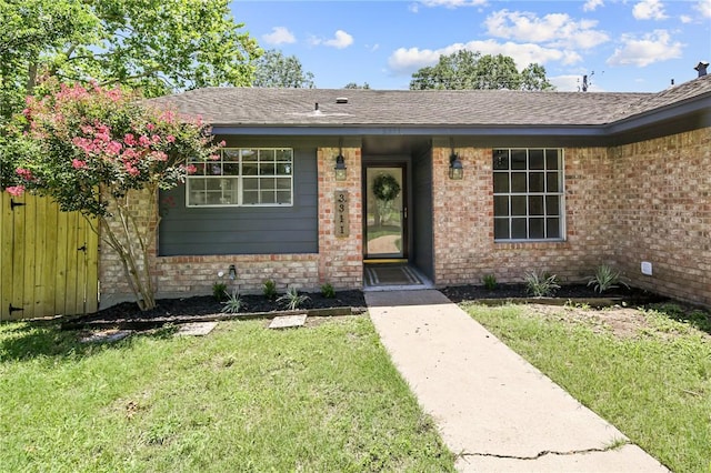 exterior space featuring a front yard and brick siding