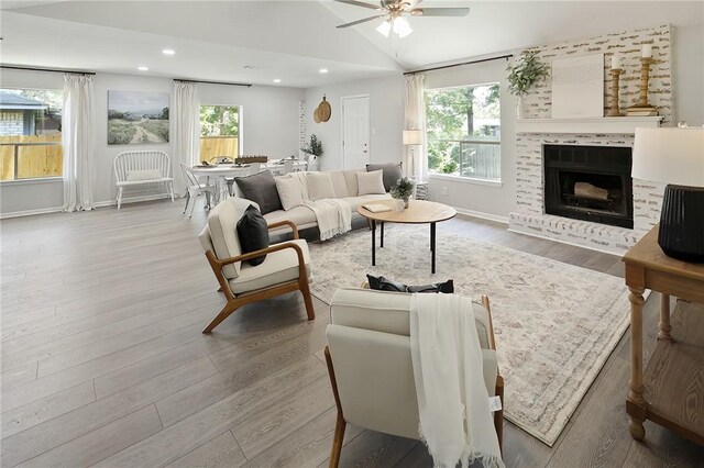 living area with wood finished floors, a ceiling fan, vaulted ceiling, and recessed lighting