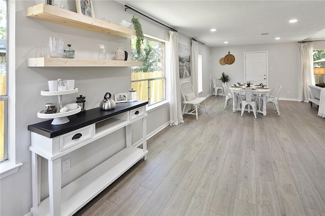 interior space featuring recessed lighting, light wood finished floors, and baseboards