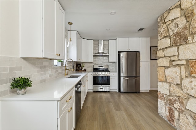 3012 Monument Dr, Round Rock, TX 78681 - kitchen featuring stainless steel appliances, wall chimney exhaust hood, backsplash, and white cabinets