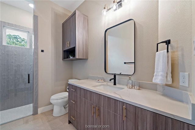 bathroom with tile patterned flooring, vanity, toilet, and a shower with door