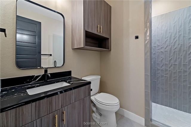 bathroom featuring tile patterned floors, a shower, vanity, and toilet