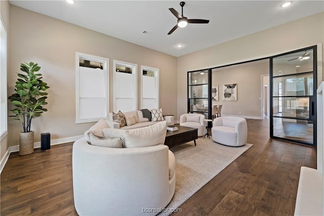 living room with dark hardwood / wood-style floors and ceiling fan