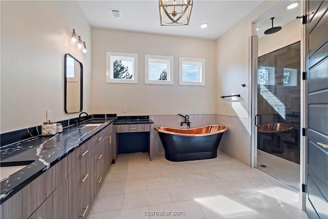 bathroom featuring tile patterned floors, vanity, and plus walk in shower