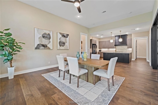 dining area with ceiling fan and hardwood / wood-style flooring