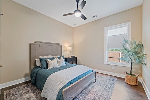 bedroom featuring ceiling fan and dark wood-type flooring