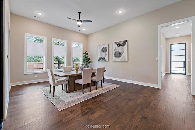 dining space with ceiling fan and dark wood-type flooring