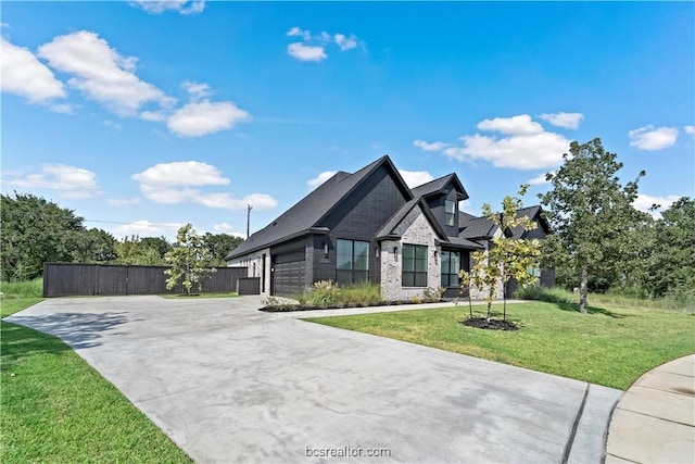 view of front of house featuring a garage and a front yard