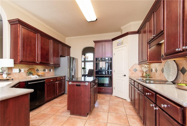 kitchen featuring a center island, backsplash, ornamental molding, and black appliances