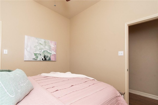 bedroom featuring hardwood / wood-style floors and vaulted ceiling