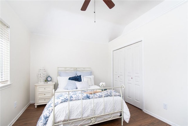 bedroom with ceiling fan, a closet, and dark wood-type flooring