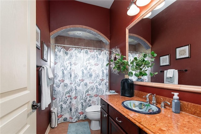 bathroom with tile patterned flooring, vanity, and toilet