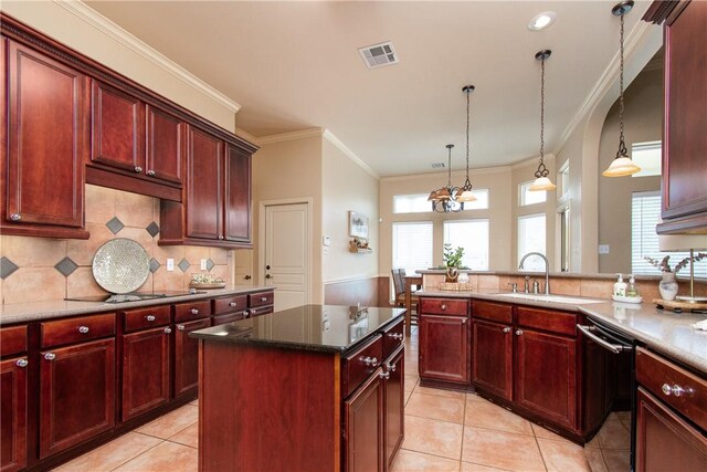 kitchen featuring dishwasher, a center island, a healthy amount of sunlight, hanging light fixtures, and sink