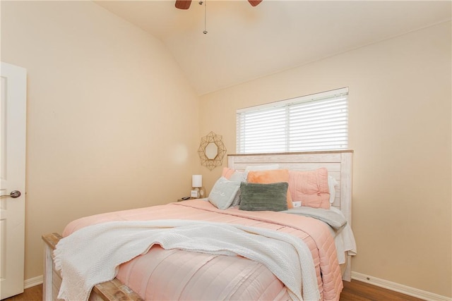 bedroom featuring dark hardwood / wood-style flooring, ceiling fan, and lofted ceiling