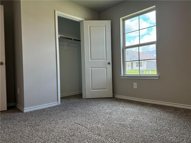 unfurnished bedroom with a closet and carpet