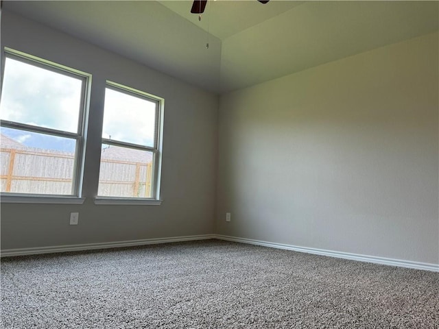 unfurnished room with carpet and ceiling fan