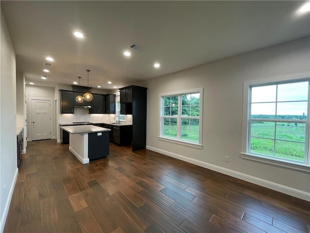 1692 Henry Prairie Rd, Franklin, TX 77856 - kitchen with a kitchen island, dark wood-style flooring, healthy amount of natural light, backsplash, and recessed lighting