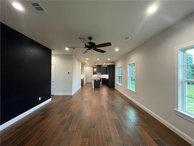 1692 Henry Prairie Rd, Franklin, TX 77856 - unfurnished living room with dark wood finished floors, plenty of natural light, ceiling fan, and recessed lighting