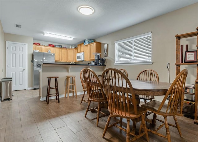 dining area with light hardwood / wood-style floors