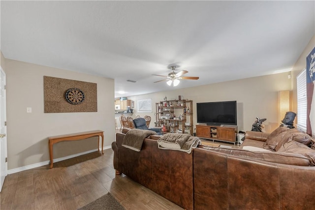 living room featuring hardwood / wood-style flooring and ceiling fan