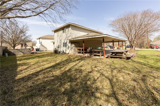 rear view of house featuring cooling unit, a patio area, and a lawn