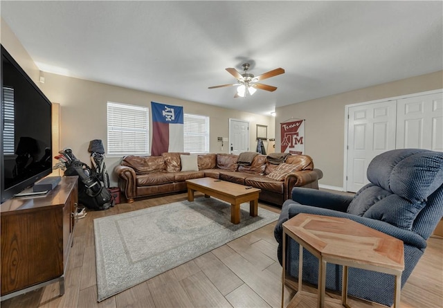 living room with ceiling fan and light wood-type flooring