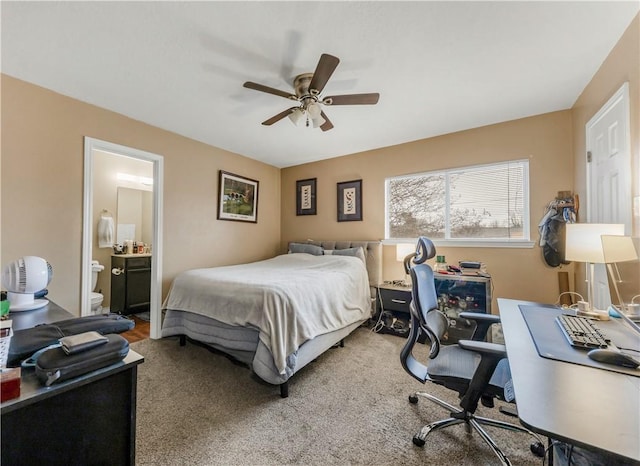 carpeted bedroom featuring ceiling fan and ensuite bathroom