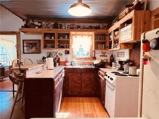 kitchen with white appliances, open shelves, light countertops, wood ceiling, and light wood-type flooring