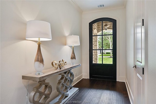 foyer featuring dark hardwood / wood-style floors and crown molding