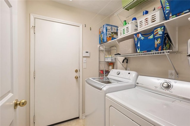clothes washing area featuring washer and clothes dryer and laundry area