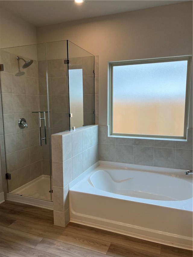 6303 Raleigh Dr, College Station, TX 77845 - bathroom with a garden tub, a shower stall, and wood finished floors