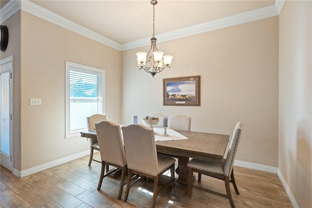 dining area with hardwood / wood-style flooring, crown molding, and a chandelier