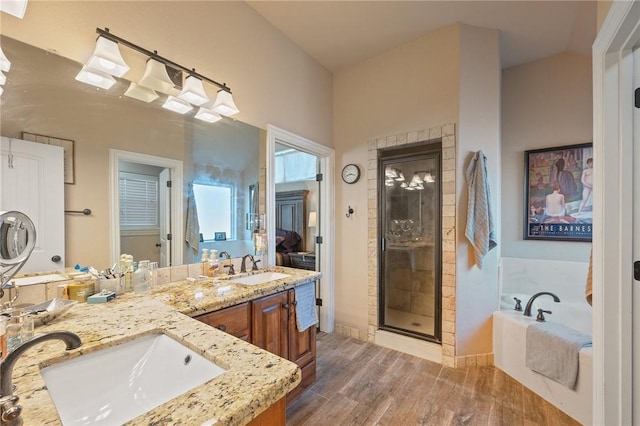 bathroom featuring vanity, plus walk in shower, and wood-type flooring