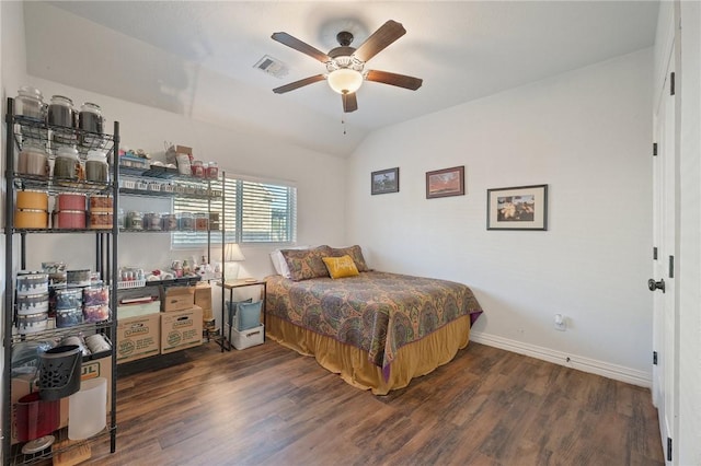 bedroom featuring ceiling fan, dark hardwood / wood-style flooring, and lofted ceiling