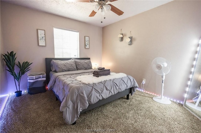 carpeted bedroom featuring a textured ceiling and ceiling fan