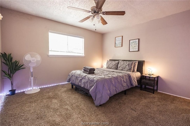 carpeted bedroom featuring ceiling fan and a textured ceiling