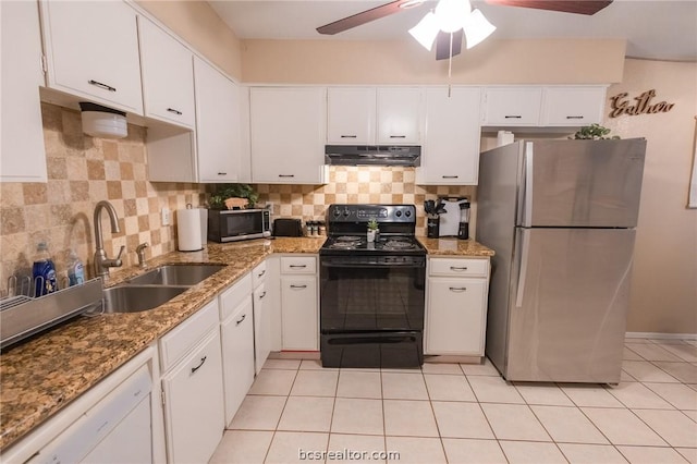 kitchen with decorative backsplash, appliances with stainless steel finishes, light tile patterned floors, stone counters, and white cabinetry