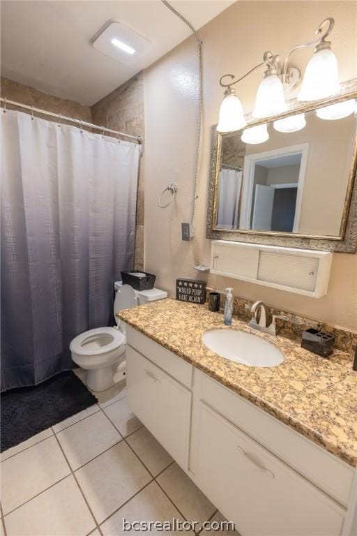 bathroom featuring tile patterned flooring, vanity, and toilet