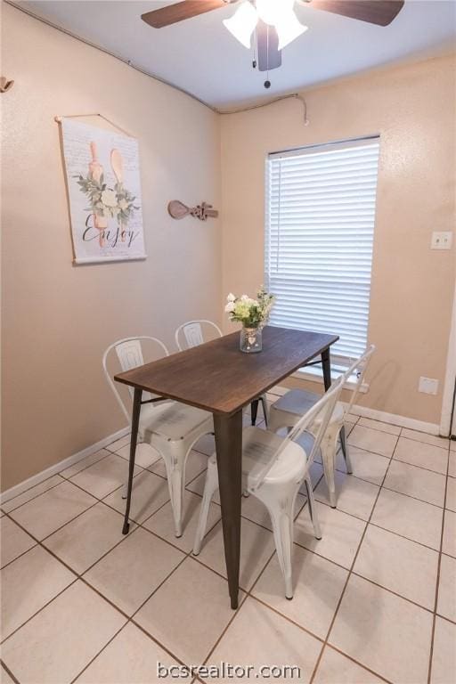 tiled dining area featuring ceiling fan