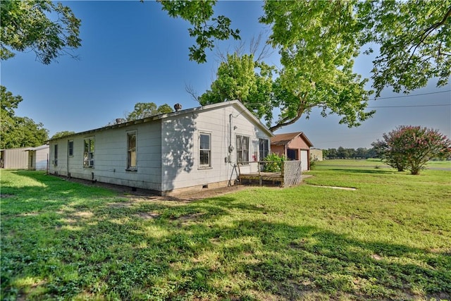 view of side of home with a yard