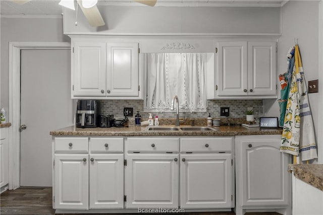 kitchen with decorative backsplash, sink, and white cabinets