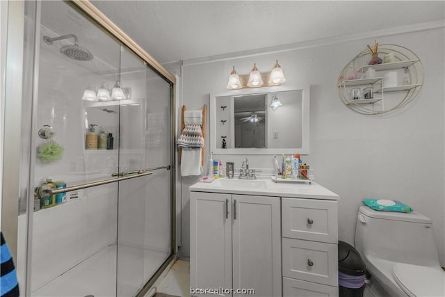 bathroom with a textured ceiling, vanity, toilet, and an enclosed shower