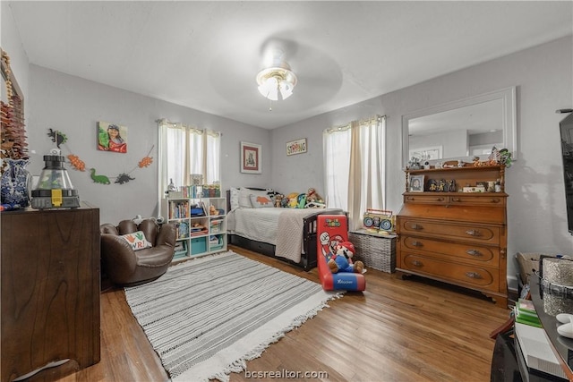 bedroom with ceiling fan and wood-type flooring