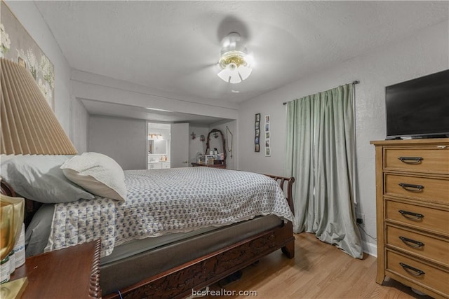 bedroom with ceiling fan and light hardwood / wood-style floors