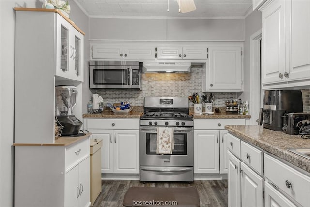 kitchen featuring white cabinetry, crown molding, wall chimney exhaust hood, and appliances with stainless steel finishes