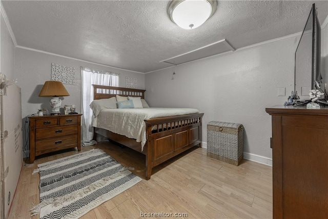 bedroom featuring a textured ceiling, light hardwood / wood-style flooring, and ornamental molding