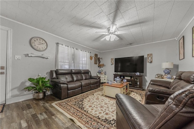 living room featuring dark hardwood / wood-style floors, ceiling fan, and crown molding