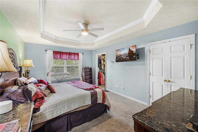 1819 Cheryl Dr, Caldwell, TX 77836 - bedroom featuring a tray ceiling, carpet flooring, ornamental molding, ceiling fan, and a walk in closet